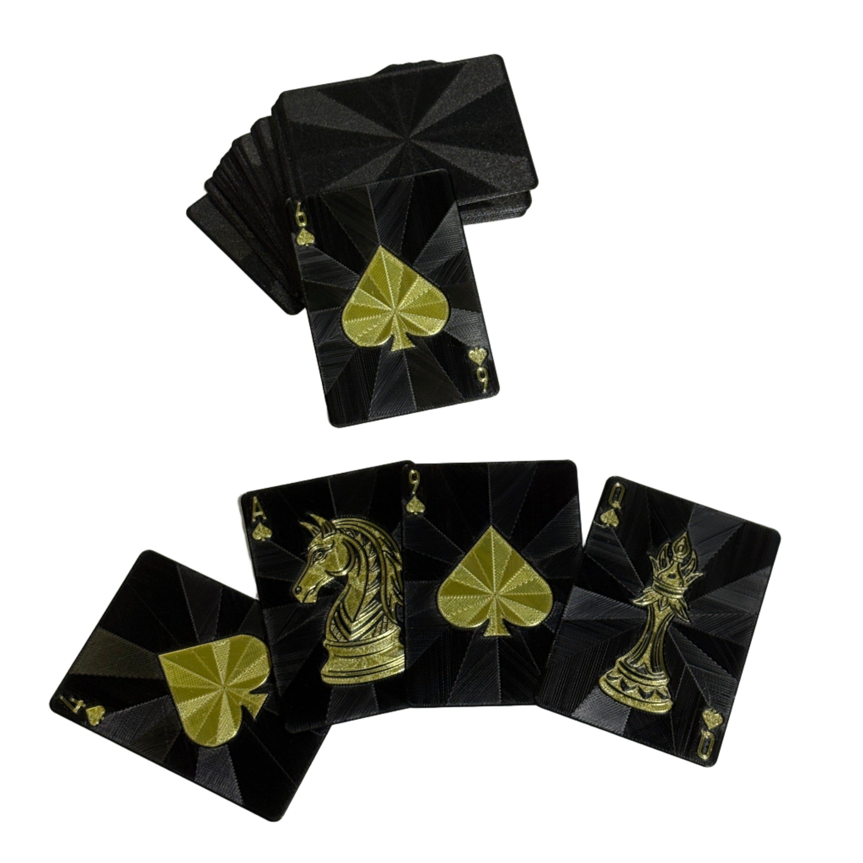 Black playing cards with gold designs on a white surface