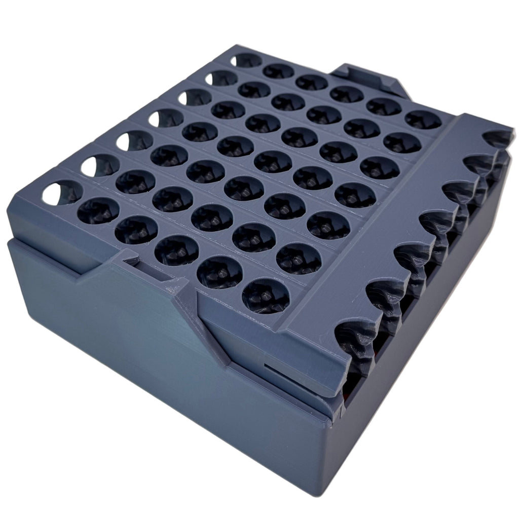 Gray plastic block with multiple cylindrical holes on a white background